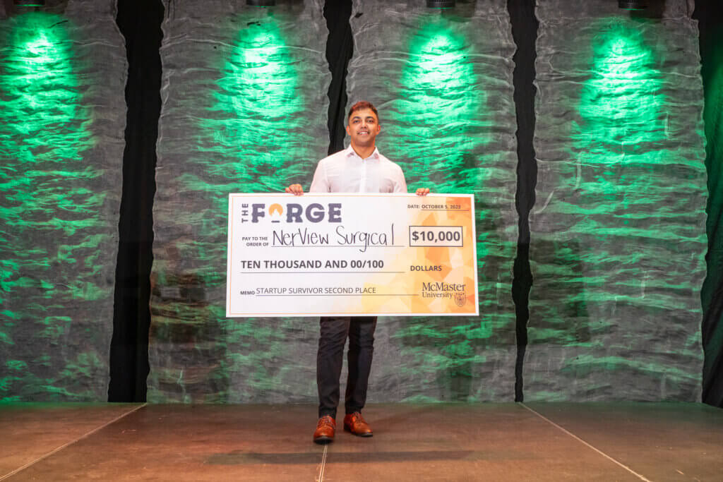 Mann Parikh, second place winner in 2023, posing with cheque on stage