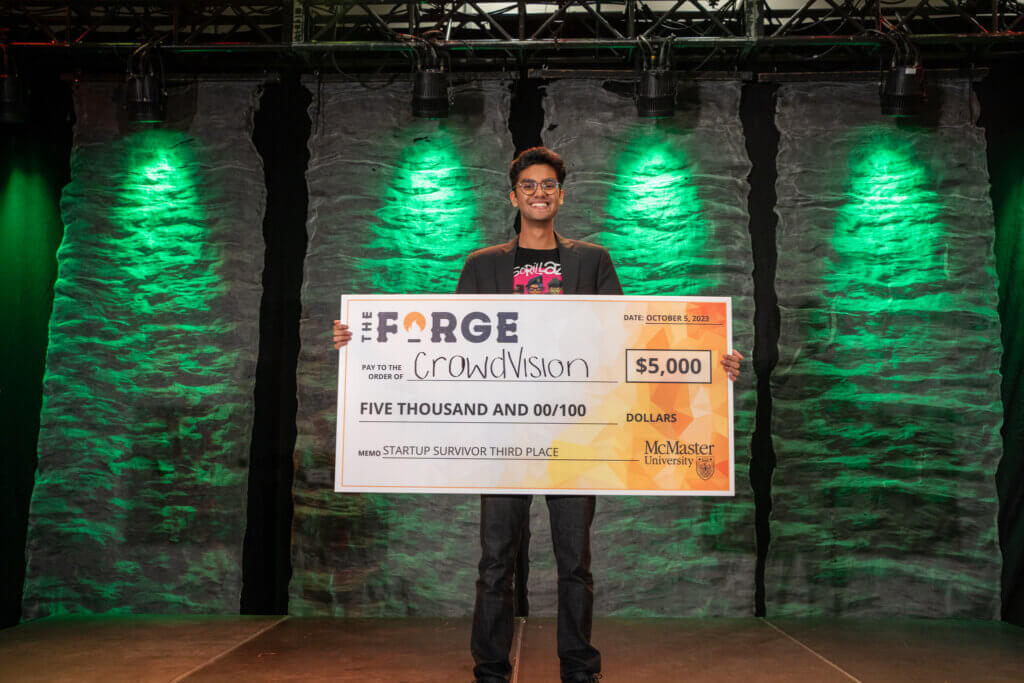 Ibrahim Iftikhar posing with his third place cheque on stage
